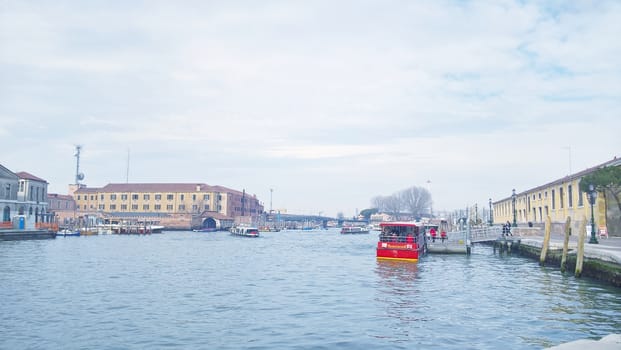 Venice, Italy - 04/24/2019: Foggy (misty) Venice. Canal (channel), historical, old houses and gondoliers with gondolas in thick fog. Scenic cityscape view. Venice. Italy. Copy space. Empty place for message. Outdoor.