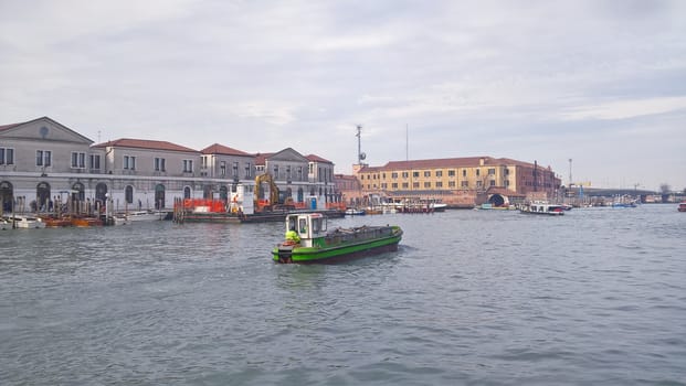 Venice, Italy - 04/24/2019: Foggy (misty) Venice. Canal (channel), historical, old houses and gondoliers with gondolas in thick fog. Scenic cityscape view. Venice. Italy. Copy space. Empty place for message. Outdoor.