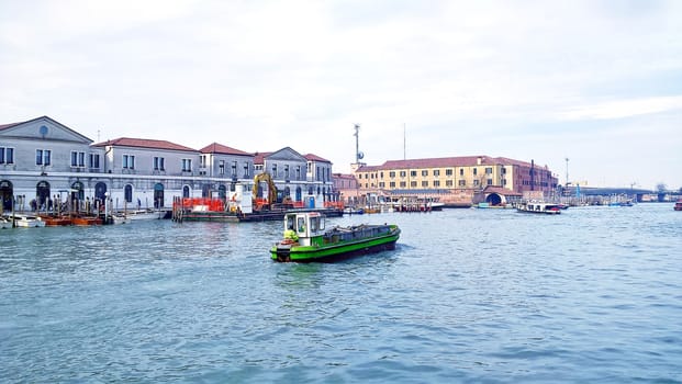 Venice, Italy - 04/24/2019: Foggy (misty) Venice. Canal (channel), historical, old houses and gondoliers with gondolas in thick fog. Scenic cityscape view. Venice. Italy. Copy space. Empty place for message. Outdoor.