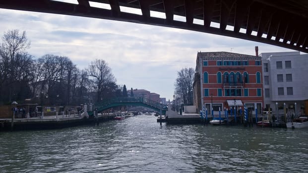 Venice, Italy - 04/24/2019: Foggy (misty) Venice. Canal (channel), historical, old houses and gondoliers with gondolas in thick fog. Scenic cityscape view. Venice. Italy. Copy space. Empty place for message. Outdoor.