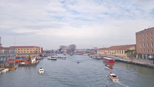 Venice, Italy - 04/24/2019: Foggy (misty) Venice. Canal (channel), historical, old houses and gondoliers with gondolas in thick fog. Scenic cityscape view. Venice. Italy. Copy space. Empty place for message. Outdoor.