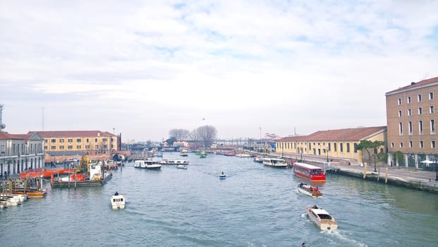 Venice, Italy - 04/24/2019: Foggy (misty) Venice. Canal (channel), historical, old houses and gondoliers with gondolas in thick fog. Scenic cityscape view. Venice. Italy. Copy space. Empty place for message. Outdoor.