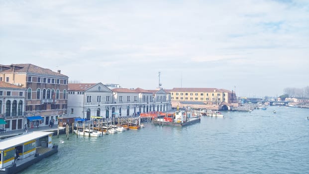 Venice, Italy - 04/24/2019: Foggy (misty) Venice. Canal (channel), historical, old houses and gondoliers with gondolas in thick fog. Scenic cityscape view. Venice. Italy. Copy space. Empty place for message. Outdoor.