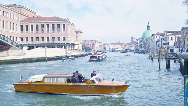 Venice, Italy - 04/24/2019: Foggy (misty) Venice. Canal (channel), historical, old houses and gondoliers with gondolas in thick fog. Scenic cityscape view. Venice. Italy. Copy space. Empty place for message. Outdoor.