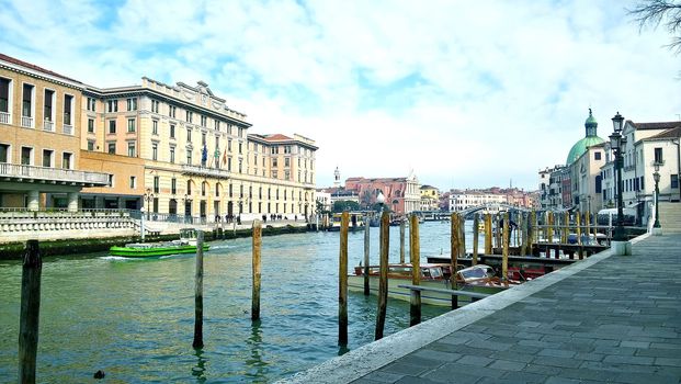 Venice, Italy - 04/24/2019: Foggy (misty) Venice. Canal (channel), historical, old houses and gondoliers with gondolas in thick fog. Scenic cityscape view. Venice. Italy. Copy space. Empty place for message. Outdoor.