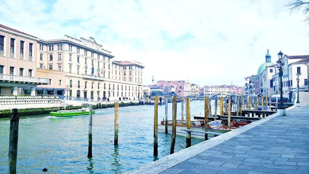 Venice, Italy - 04/24/2019: Foggy (misty) Venice. Canal (channel), historical, old houses and gondoliers with gondolas in thick fog. Scenic cityscape view. Venice. Italy. Copy space. Empty place for message. Outdoor.