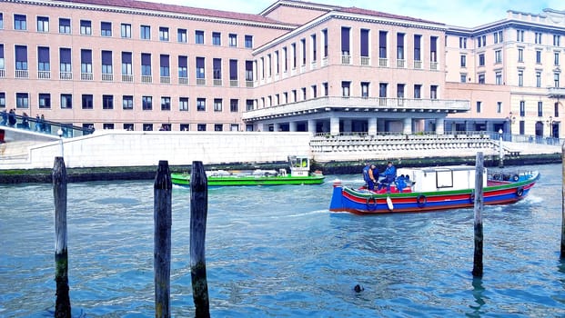 Venice, Italy - 04/24/2019: Foggy (misty) Venice. Canal (channel), historical, old houses and gondoliers with gondolas in thick fog. Scenic cityscape view. Venice. Italy. Copy space. Empty place for message. Outdoor.