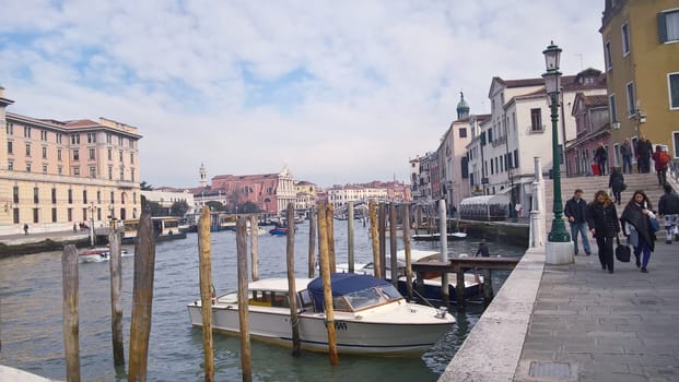 Venice, Italy - 04/24/2019: Foggy (misty) Venice. Canal (channel), historical, old houses and gondoliers with gondolas in thick fog. Scenic cityscape view. Venice. Italy. Copy space. Empty place for message. Outdoor.