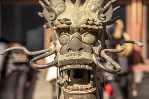 Chinese Dragon statue head with open jaws from Ming dynasty era, in the Forbidden City, Beijing, China