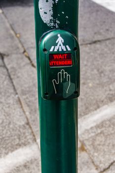 Traffic light with wait - attendere sign at Roman street in Italy.