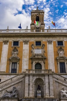 External day view of Palazzo Senatorio at piazza del Campidoglio with Italian and city of Rome flag.