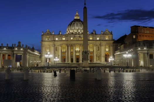 St. Peter’s square with illuminated facade view of Basilica and Apostolic Palace - Palazzo Apostolico, Pope’s official residence.