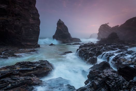 Sunrise along rugged formidable coastline of Australia, sharp pinnacle rocks protrude from the ocean