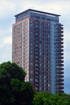 MANILA, PH - JULY 6: Tall building surrounding Rizal park on July 6, 2016 in Manila, Philippines.