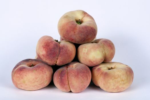 Saturn peaches flat peaches also known doughnut peach isolated on a white background