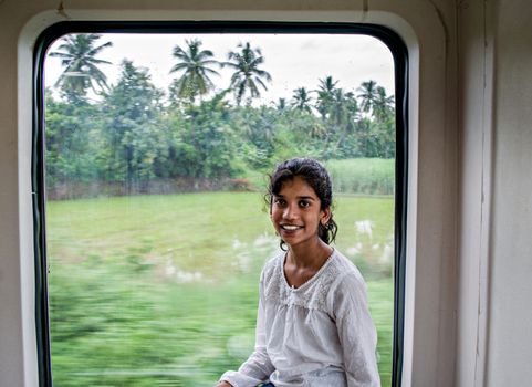 Kottavalasa, Andhra Pradesh, India:August 28th, 2017-Young  girl enjoying the ride of vistadome train coach on way to scenic Araku valley.