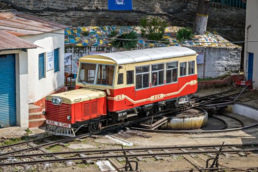 Shimla, Himachal Pradesh, India- April 15th, 2015: Narrow gauge, self propelled, rail car resting on a turn table after its uphill trip from Kalka.
