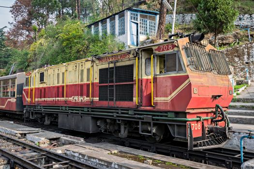 Barog, Himachal Pradesh, India- April 14th, 2015:Narrow gauge locomotive with Kalka-Shimla Shivalik deluxe express, takes a stop at Barog station.