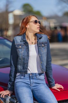 A gorgeous redhead model enjoys a spring day outdoors