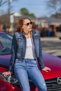 A gorgeous redhead model enjoys a spring day outdoors