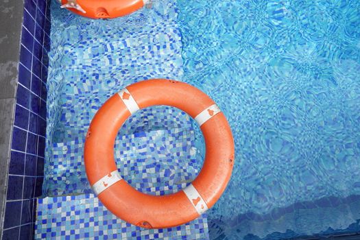 Safety equipment, life buoys, or rescue red buoys in the pool to help people from drowning.