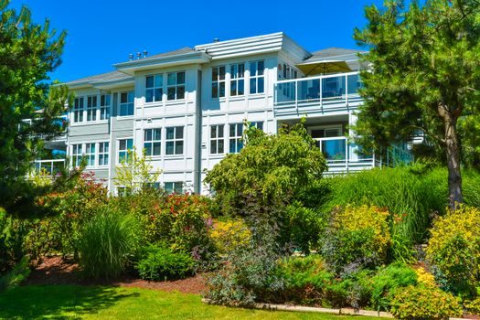 Luxury apartment building with landscaped lawn in front