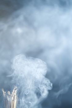 Incense burning incense, white smoke, black background, used as background image Paying homage to the sacred objects of the people of Buddhism according to their beliefs and beliefs.