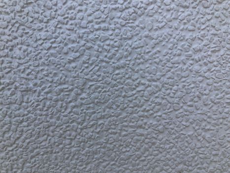 The gray cement background wall has a pattern made of cement plaster.