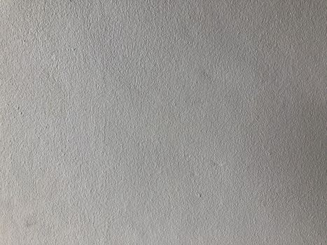 The gray cement background wall has a pattern made of cement plaster.