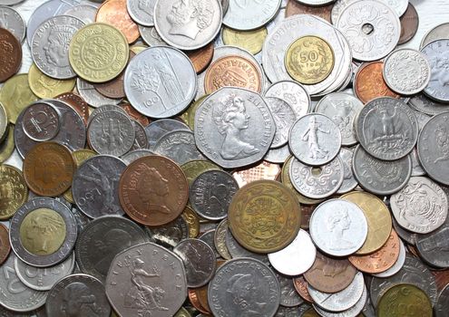 The picture shows background with old coins from all over the world