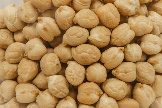 Back to the natural vegan food theme concept background: macro close up view view of raw dried chickpeas in a glass jar
