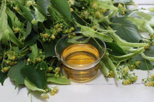 The picture shows lime blossom tea on white boards