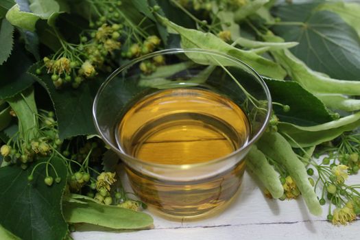 The picture shows lime blossom tea on white boards