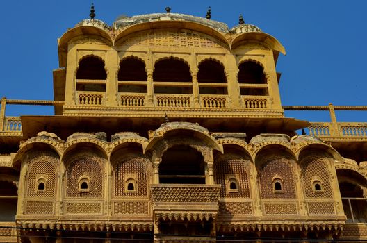 Facade of a traditional Rajasthani haveli with window at Patwon ki haveli in Jaisalmer, Rajasthan, India. Series of early-1800s palaces, now a museum featuring intricate carvings, furniture & artwork