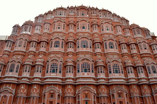 Low angle shot of Hawa Mahal from across the street. Hawa Mahal is constructed of red and pink sandstone. The structure was built in 1799 by Maharaja Sawai Pratap Singh in Jaipur, Rajasthan, India.