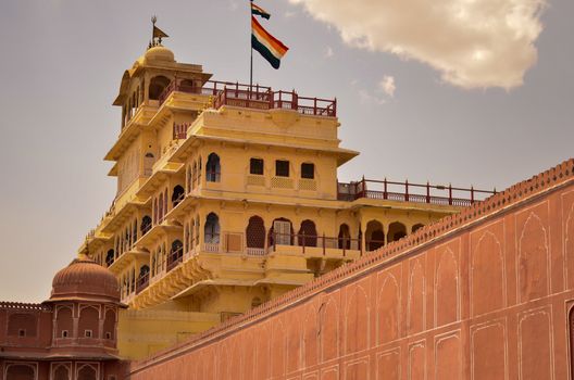Low angle shot of the top floor which is a restricted area where royal flag is hoisted in Jaipur city palace, Rajasthan, India. An Indian National flag is hoisted there