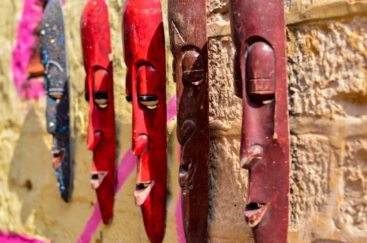Elongated wooden masks on display and sale in a street shop inside Golden Jaisalmer Fort in Jaisalmer, Rajasthan, India.