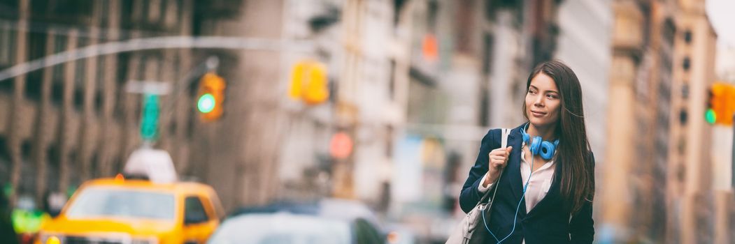 New York City lifestyle Young Asian woman walking commute in NYC street. Urban people hipster girl in traffic banner panorama. Chinese lady looking to side with purse and headphones for commute.