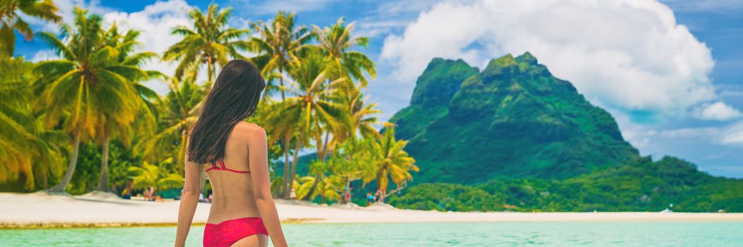 Tahiti luxury travel beach in Bora Bora cruise destination. Idyllic paradise banner background woman in bikini relaxing walking in sun.