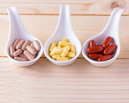 Vitamin pill on wood table, healthy concept