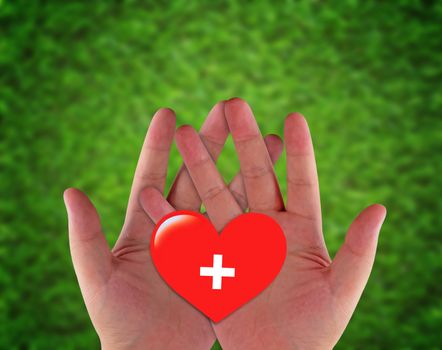 Health care and insurance concept, hand and red heart paper cut on green blur background