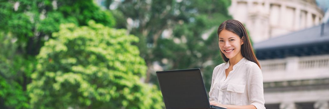 Asian woman working on laptop computer laptop at outside cafe city park, Hong Kong, China. Young student sitting outdoor, freelancer or remote work on Asia travel. Banner panorama.