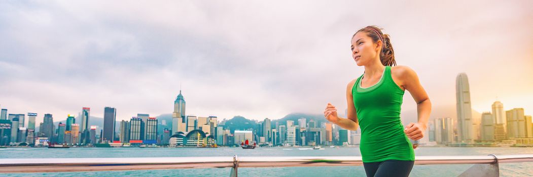 Hong Kong city China travel sightseeing fitness woman jogging at skyline banner panorama . Healthy active lifestyle panoramic view of urban landscape.