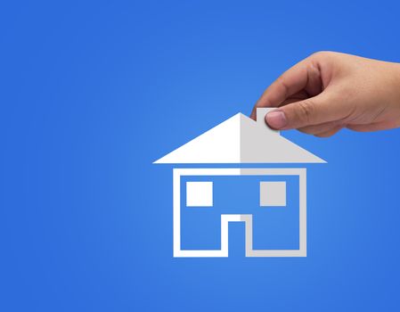 Real estate hand agent holding white paper house on blue background, bank home loan concept