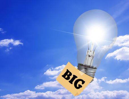 Think big concept, light bulb fly on blue sky background