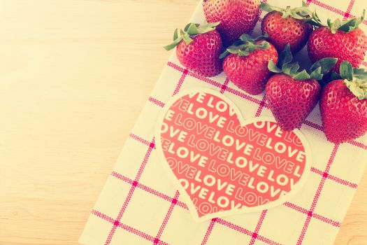 Group of strawberry and love sign in retro style on wooden background  