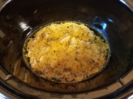 beef stew in brown sauce cooking in crock pot