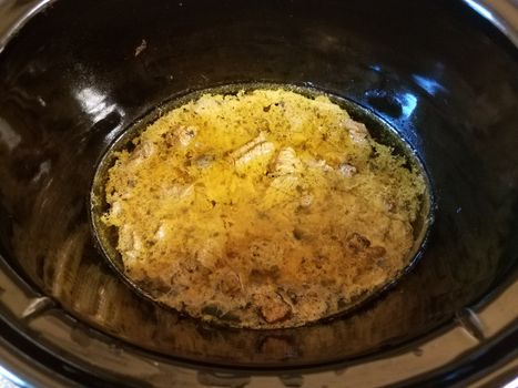 beef stew in brown sauce cooking in crock pot