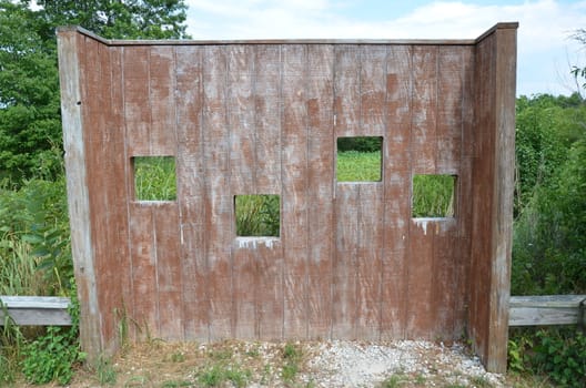 wood animal blind with square holes or viewing windows