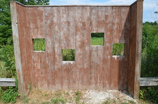 wood animal blind with square holes or viewing windows